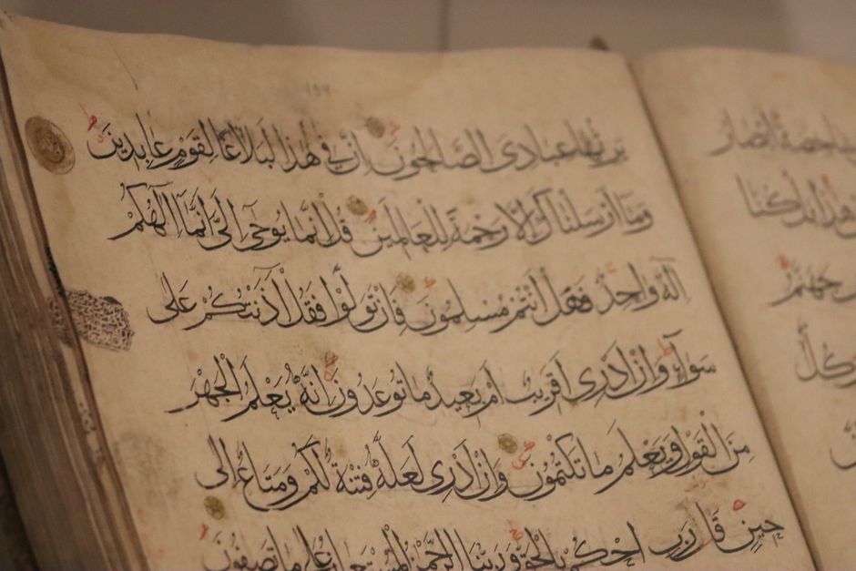A detailed view of ancient book pages showcasing intricate Arabic calligraphy.
