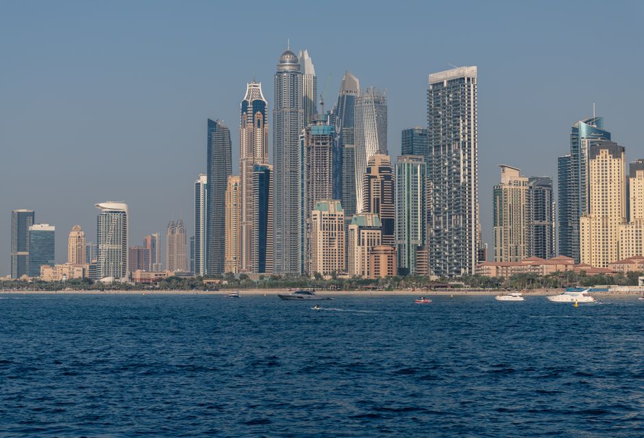 Breathtaking view of Dubai Marina's skyscrapers from the ocean during the day.