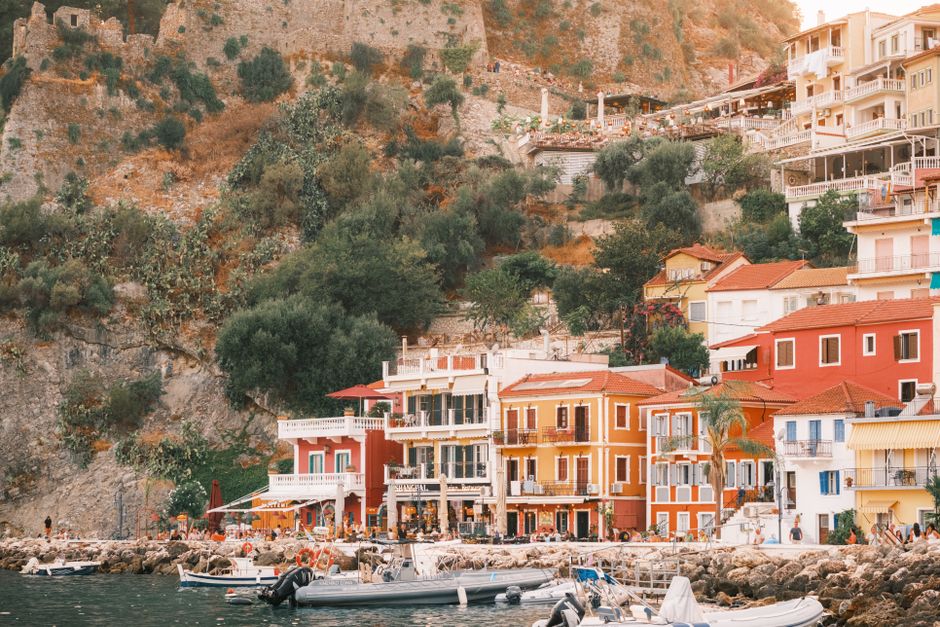 Colorful buildings line the waterfront of Parga, Greece, offering a picturesque Mediterran