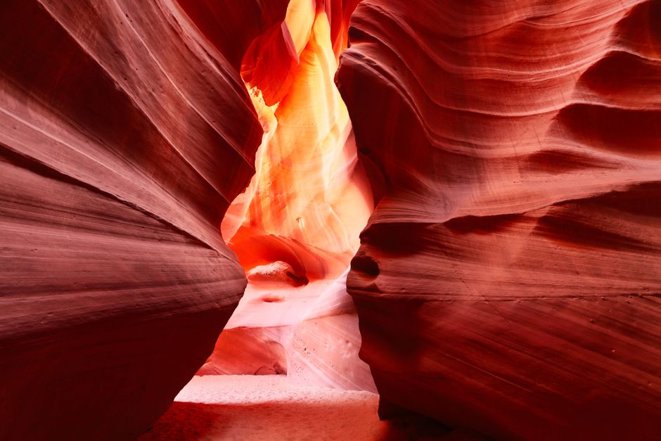 Vibrant red and orange hues illuminate the famous Antelope Canyon rock formation in Arizona.