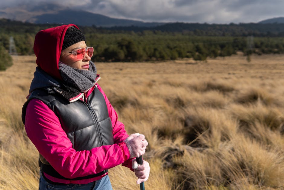 A woman in warm clothing enjoys a scenic hike in Puebla, Mexico, surrounded by nature.
