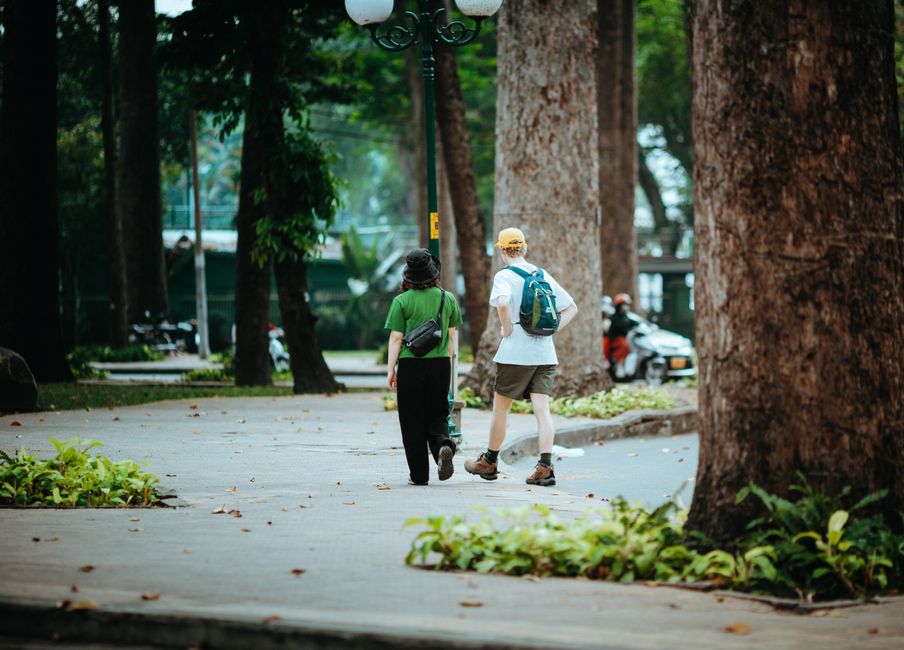 Casual stroll in a lush park in Ho Chi Minh City, Vietnam, capturing urban nature's tranquility.