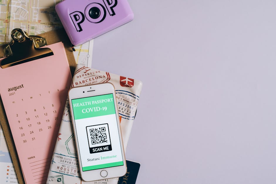 Flat lay image of a health passport with a COVID-19 QR code, calendar, and map.