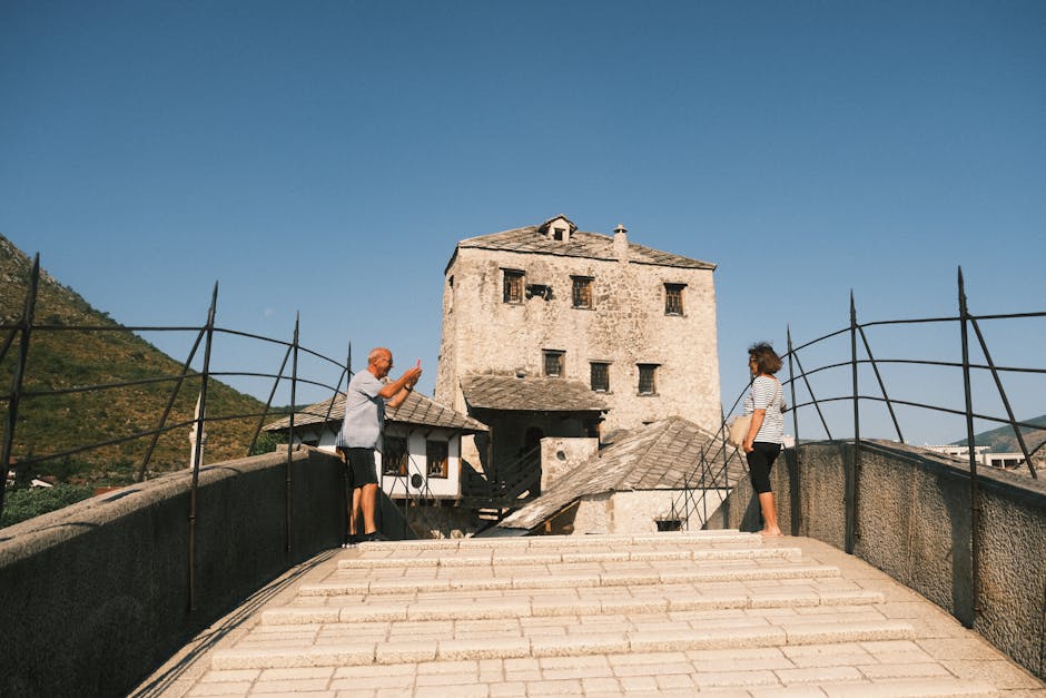 Tourists capturing a moment on the historic Stari Most in Mostar, Bosnia and Herzegovina.